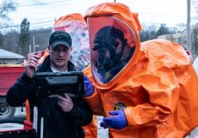 2NYT1HR Members of a three-person survey team element within the Ohio National Guard's 52nd Civil Support Team prepare their personal protective equipment before entering an affected area to collect ground and air samples from public buildings following a train derailment in East Palestine, Ohio, Feb. 7, 2023. The 52nd CST is a highly specialized unit that trains year-round to respond to large-scale incidents involving hazardous materials.